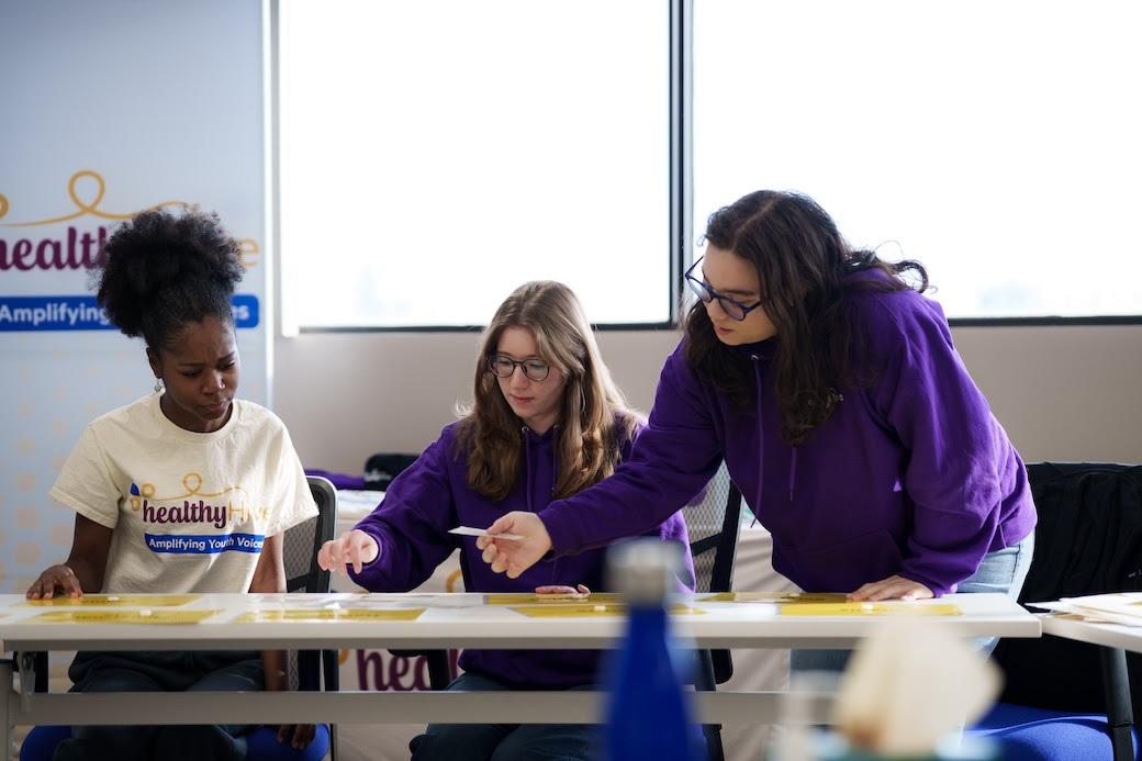 Three women working together at a table