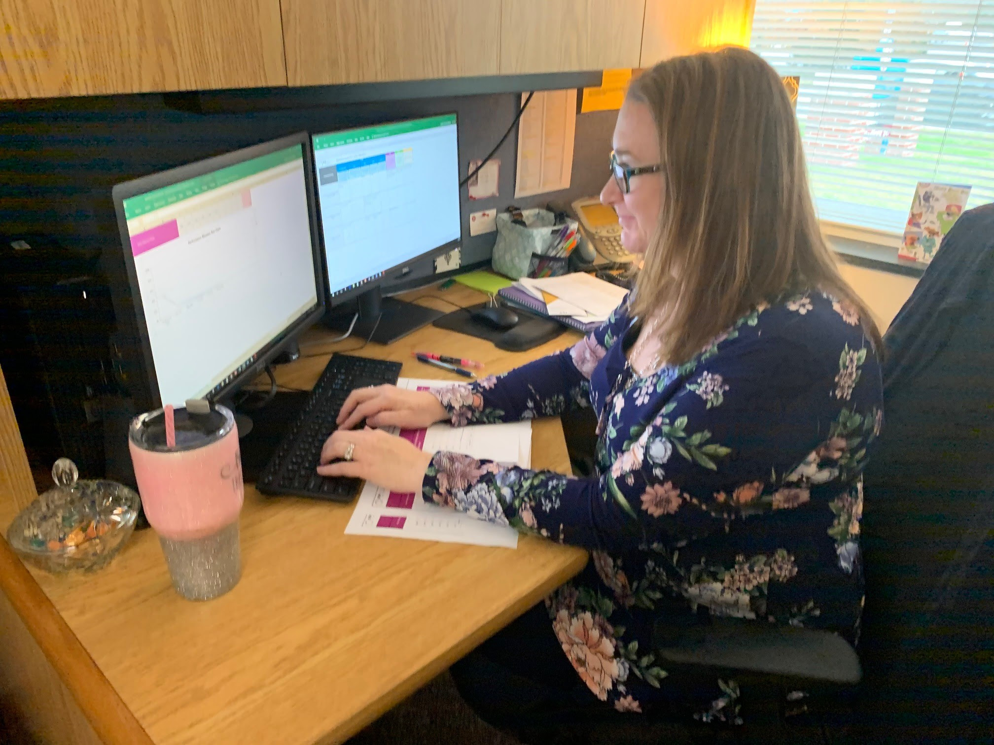 Christina Farmer sits at her desk and enters FPAR data into her computer.