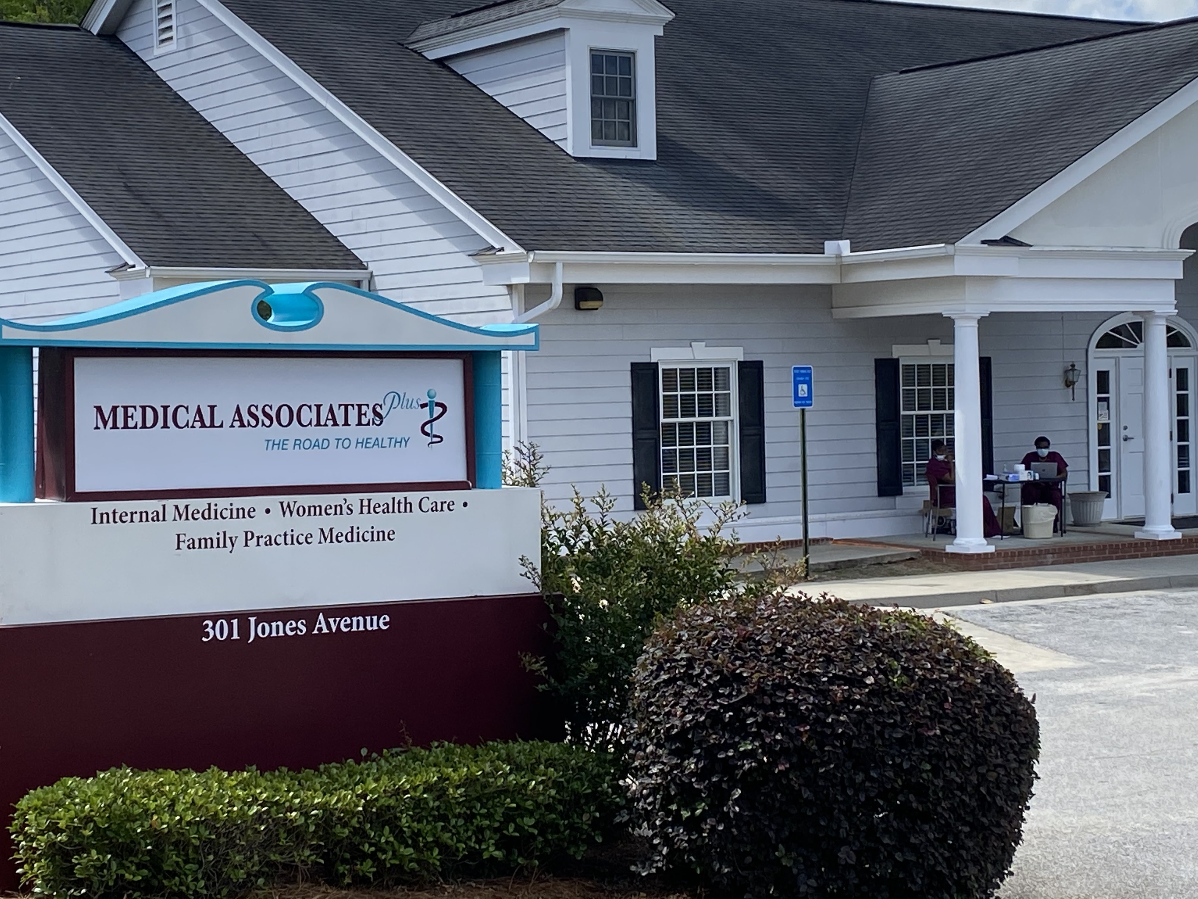Outside shot of Medical Associates Plus. The building looks like a large white sided house.